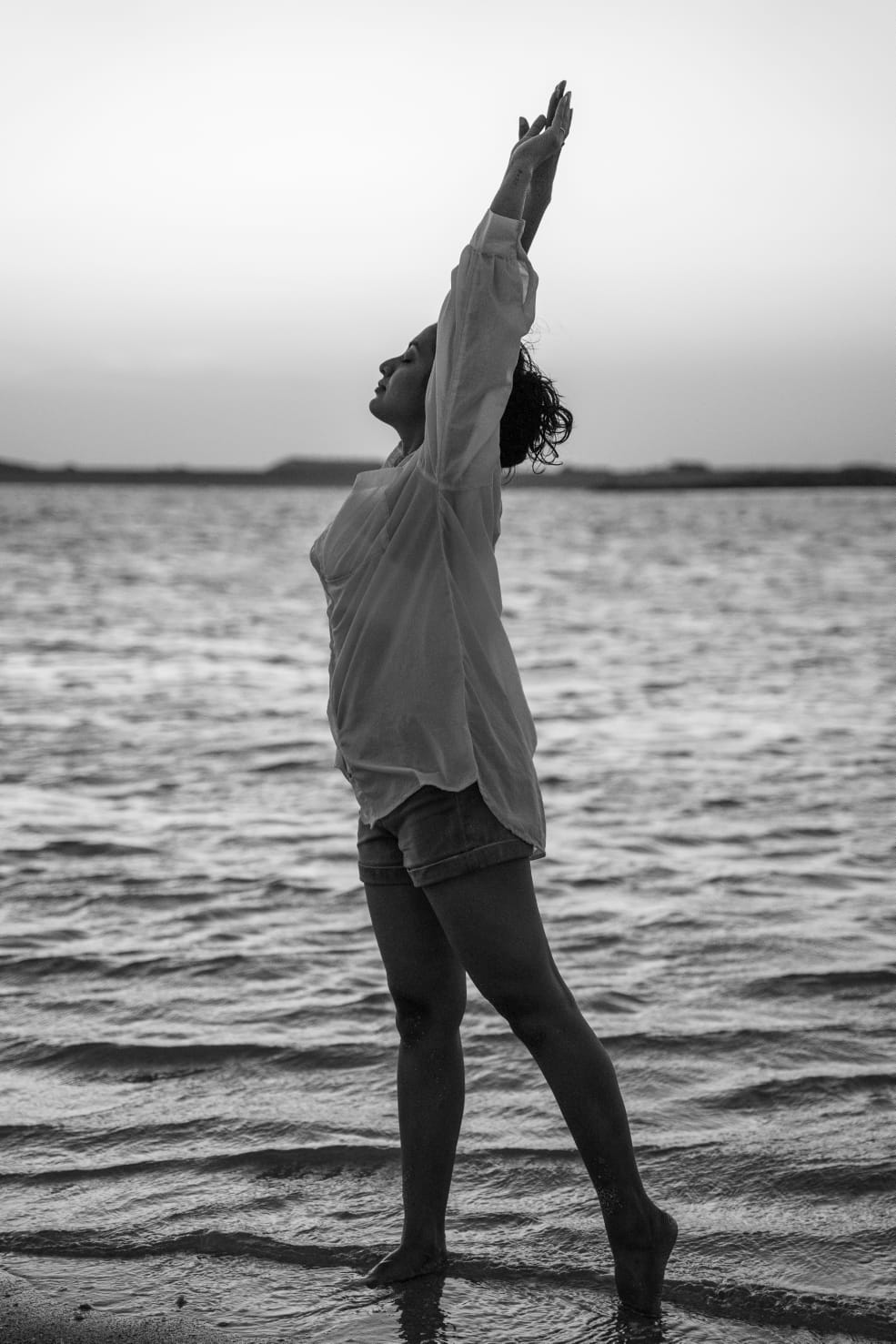 Pooja Venugopal stretching at the water's edge